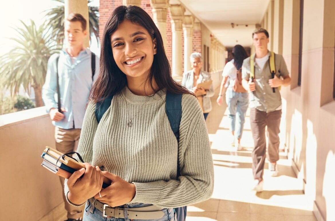 University student, indian woman and portrait at campus outdoor with books of learning, education o University student, indian woman and portrait at campus outdoor with books of learning, education o